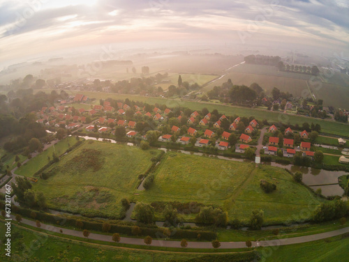 drone photo of the Park Ijsselhof near Andijk in the Netherlands with fog and rising sun photo