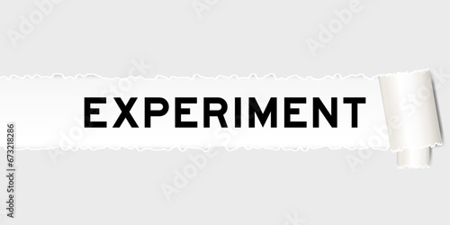 Ripped gray paper background that have word experiment under torn part