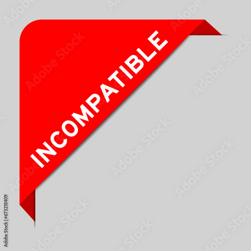 Red color of corner label banner with word incompatible on gray background
