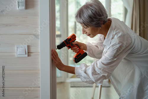 Elderly woman does minor home repairs on her own