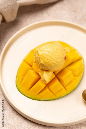 Natural mango ice cream on a slice of ripe mango