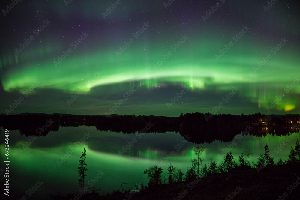 Northern lights with mirror in the lake