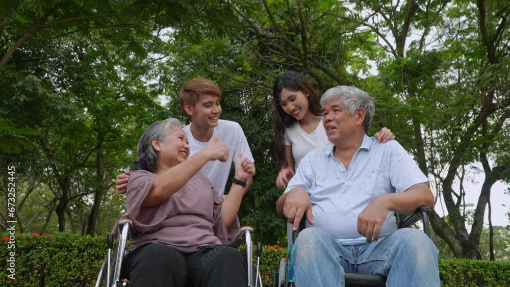 Group of happy grandparents and grandchild talking and laugh together, grandparent sitting on wheelchair. Retirement lifestyle with family, good generation relationship in family. senior live concept Group of happy grandparents and grandchild talking and laugh together, grandparent sitting on wheelchair. Retirement lifestyle with family, good generation relationship in family. senior live concept