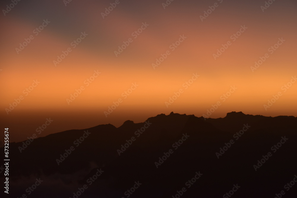 Orange sky at a stunning sunset above the clouds on Mount Kilimanjaro in Tanzania, Africa