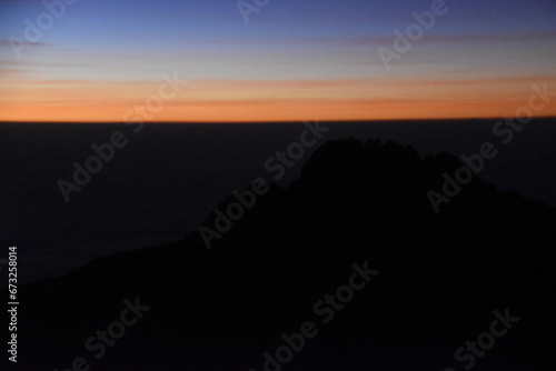 Orange sky at a beautiful sunset above the clouds on Mount Kilimanjaro in Tanzania, Africa