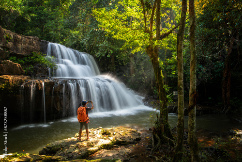 Man  of a waterfall and morning light at pangsida waterfall  in pangsida national park, sakaeo province  Thailand. photo