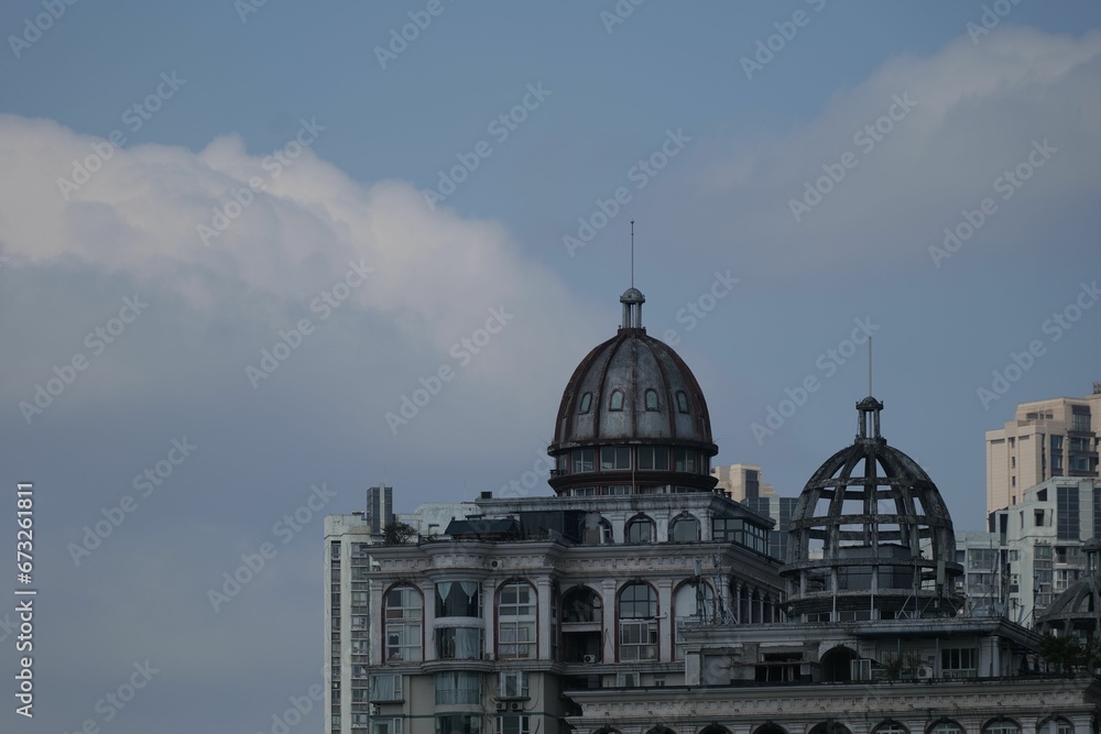 Old weathered building with a domed roof in the city skyline