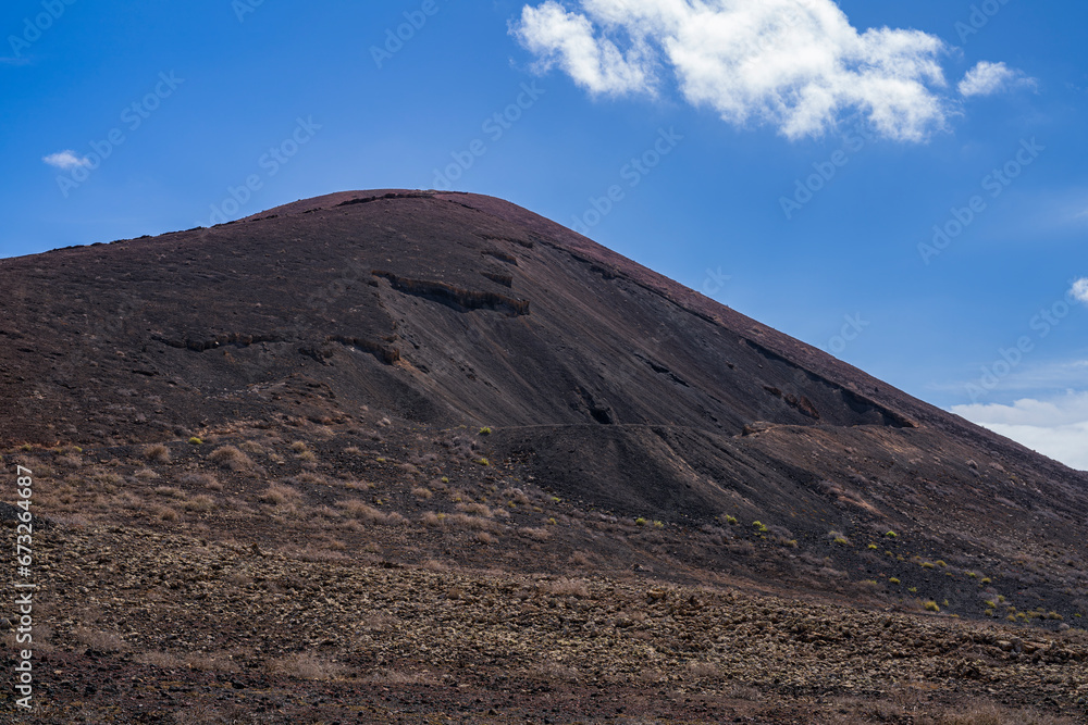 View of the impressive crater on the side of the slope of one of the most important volcanoes on the island. Photography taken in Fuerteventura, Canary Islands, Spain View of the impressive crater on the side of the slope of one of the most important volcanoes on the island. Photography taken in Fuerteventura, Canary Islands, Spain