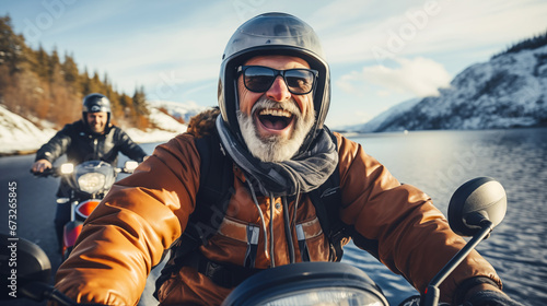 Portrait of happy confident senior motorcyclists travels through the Norwegian fjords. Concept of active age