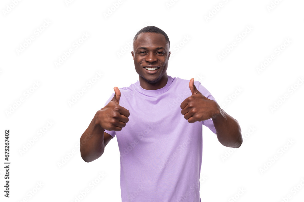 young positive american man in a lilac t-shirt is inspired by an idea and success on a white background young positive american man in a lilac t-shirt is inspired by an idea and success on a white background
