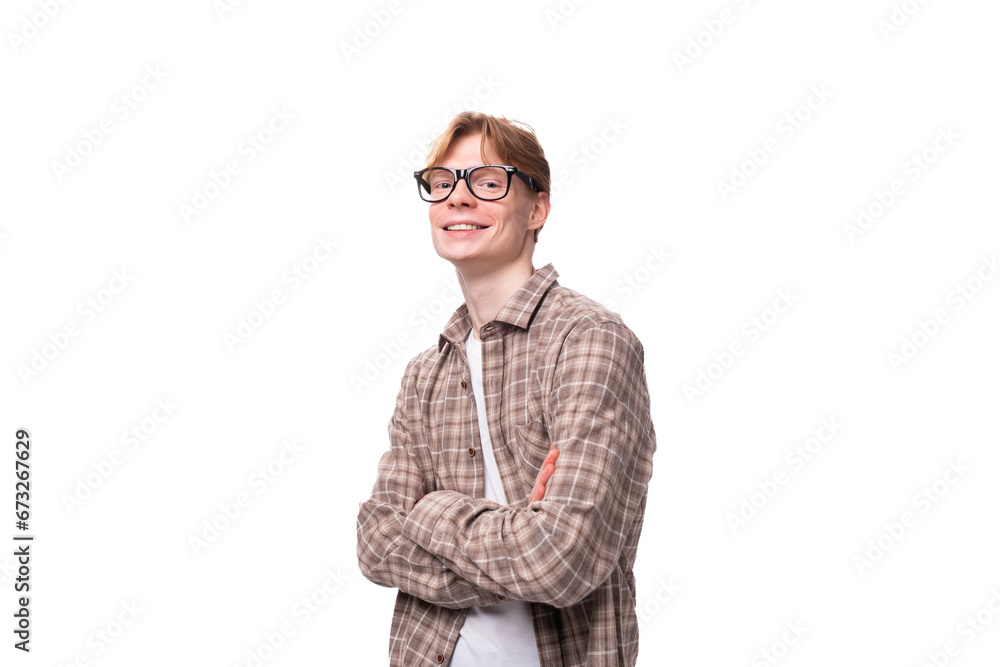 young student guy with red hair in glasses and a shirt smiling on a white background with copy space
