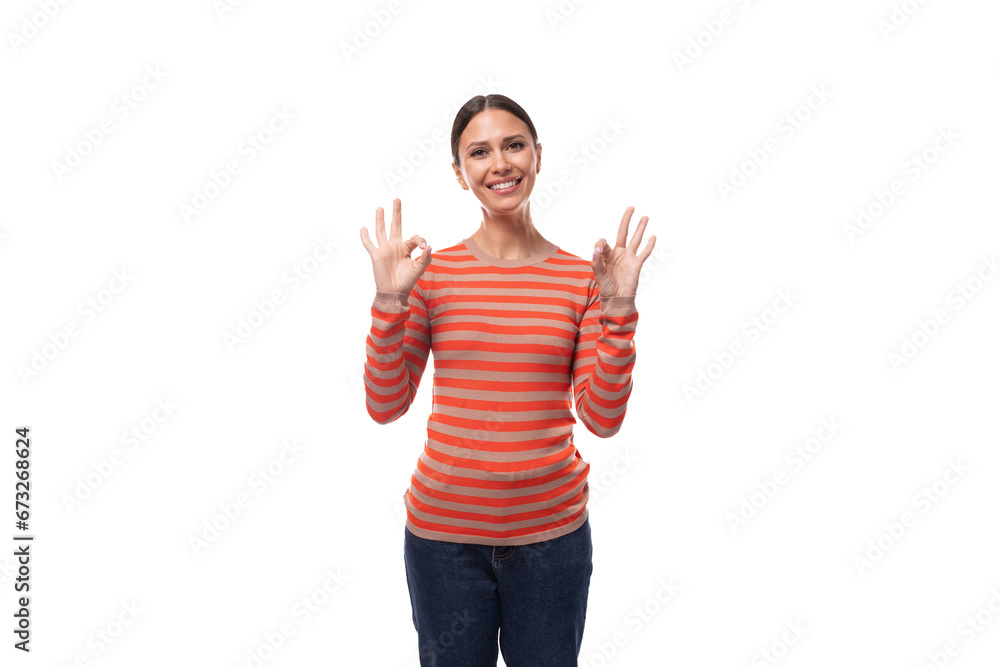 a pretty young adult woman with black hair dressed in an orange sweater is actively gesturing on a white background with copy space a pretty young adult woman with black hair dressed in an orange sweater is actively gesturing on a white background with copy space
