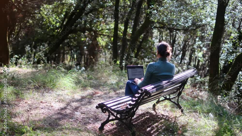 Young woman works on her laptop in the midst of nature, far from big cities and offices. Digital nomad and remote work for freelancers, creative professionals with freedom of movement and finance. Young woman works on her laptop in the midst of nature, far from big cities and offices. Digital nomad and remote work for freelancers, creative professionals with freedom of movement and finance.
