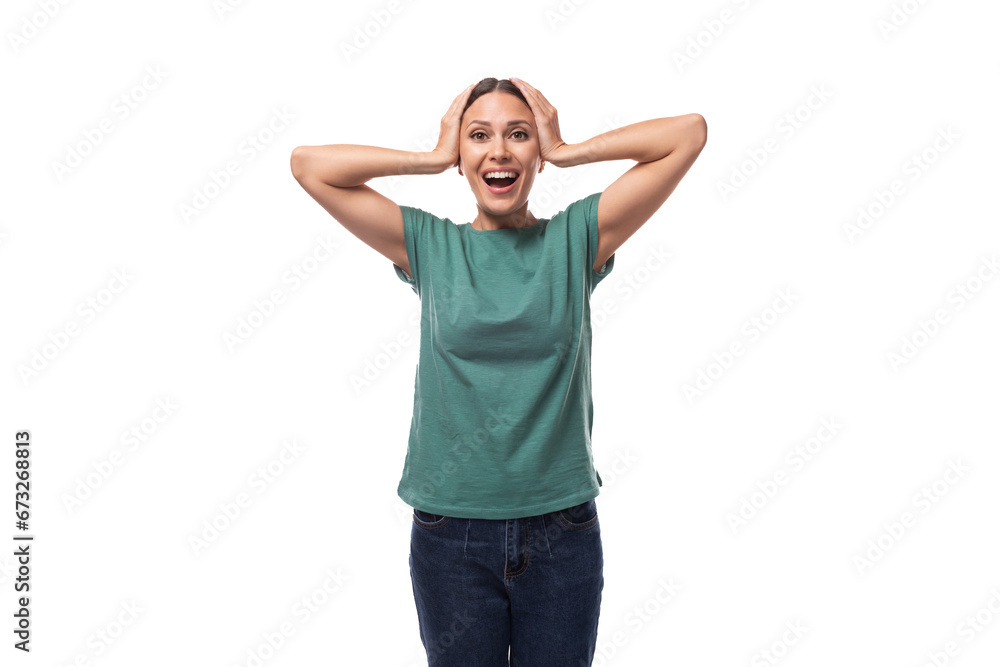 young emotional brunette woman in a t-shirt and jeans on a white background with copy space