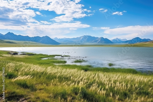 Steppe Lake. Beautiful landscape of a lake in the steppe against the backdrop of mountains, hills and a beautiful sky with clouds. photo