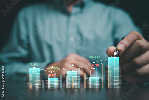 Businessman hand drawing virtual increasing graph with coins stacking, Business investment profit and deposit dividend saving growth concept.