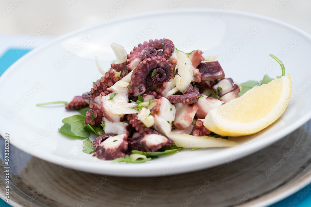 Sea octopus with salad, steamed and served with Sorrento lemons Sea octopus with salad, steamed and served with Sorrento lemons