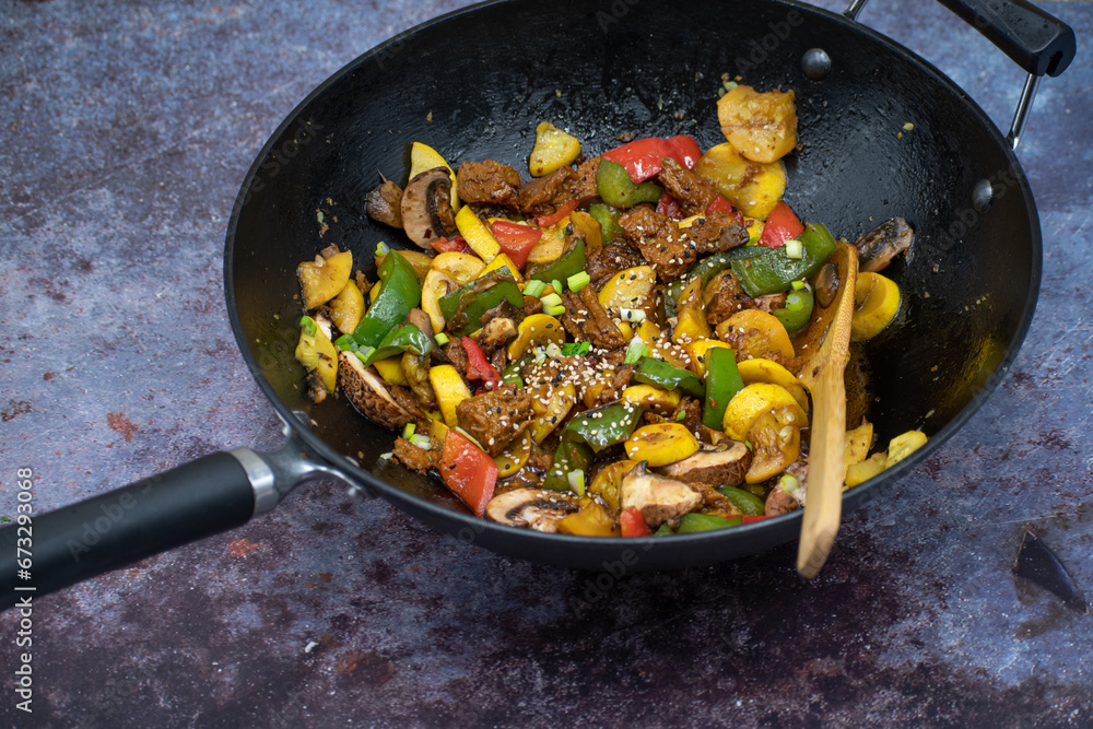 Vegan meat and vegetables stir fry in wok Vegan meat and vegetables stir fry in wok