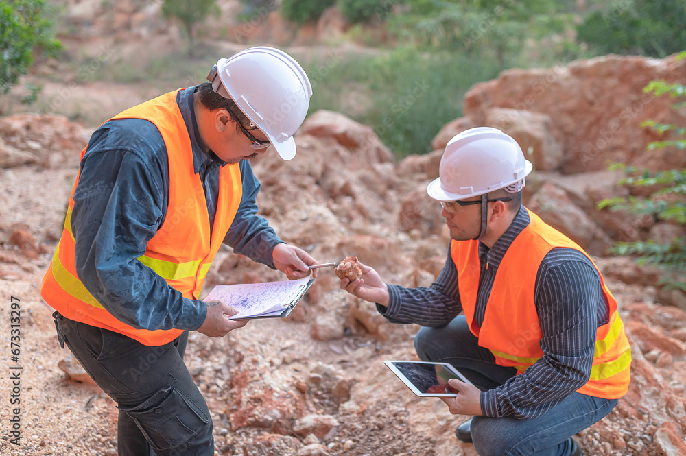 Geologist surveying mine,Explorers collect soil samples to look for minerals. Geologist surveying mine,Explorers collect soil samples to look for minerals.