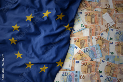 colorful waving national flag of european union on a euro money background. finance concept photo