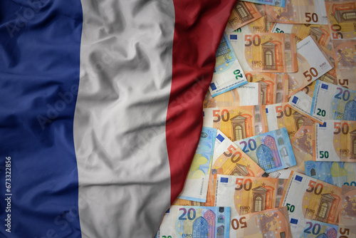 colorful waving national flag of france on a euro money background. finance concept photo