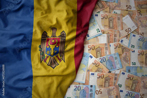 colorful waving national flag of moldova on a euro money background. finance concept