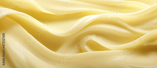 Apply butter to the surface in a curled motion capturing a close up photo that highlights the texture of the butter