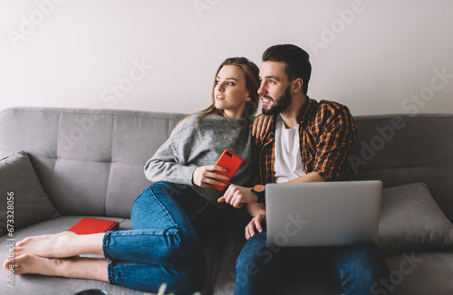 Content couple looking away during remote work