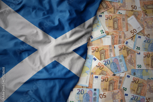 colorful waving national flag of scotland on a euro money background. finance concept photo