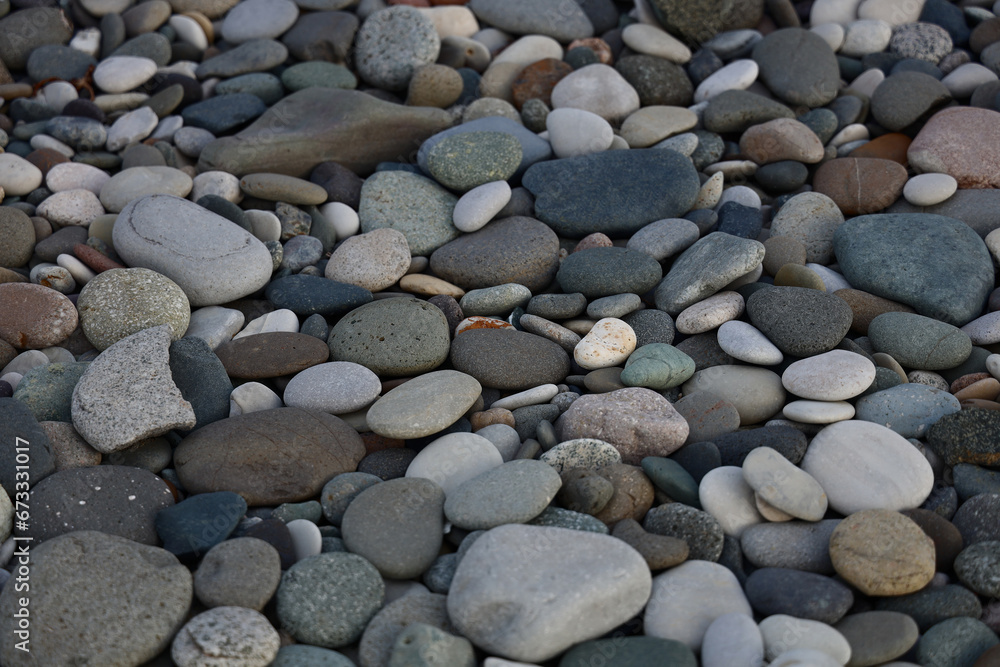 Sea of grey pebbles wallpaper. Gray beach rounded stones background. backdrop of stones on a beach of Black Sea. For banner, postcard, book illustration. Sea of grey pebbles wallpaper. Gray beach rounded stones background. backdrop of stones on a beach of Black Sea. For banner, postcard, book illustration.