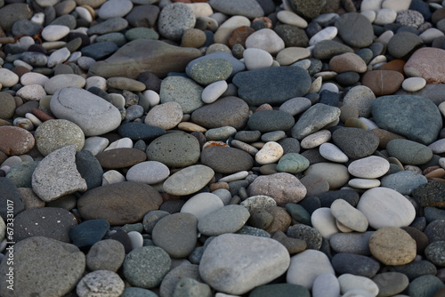 Sea of grey pebbles wallpaper. Gray beach rounded stones background. backdrop of stones on a beach of Black Sea. For banner, postcard, book illustration.