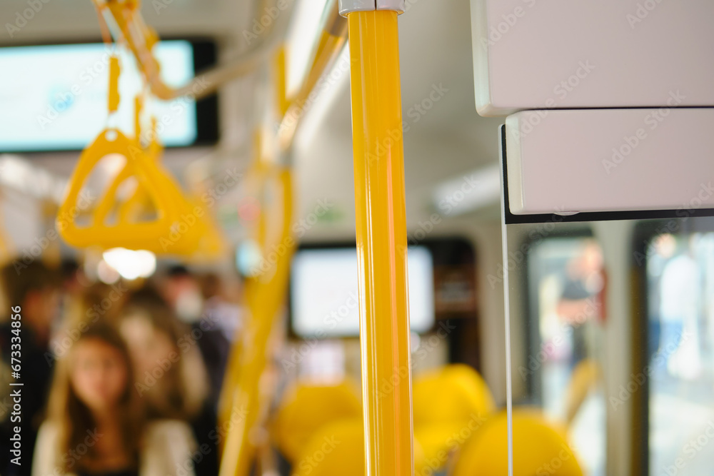 Interior of a bus with yellow seats and passengers in the background