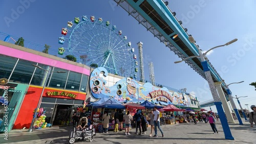 Tourists traveling in Wolmi theme park with sky train and ferris wheel on Wolmido island