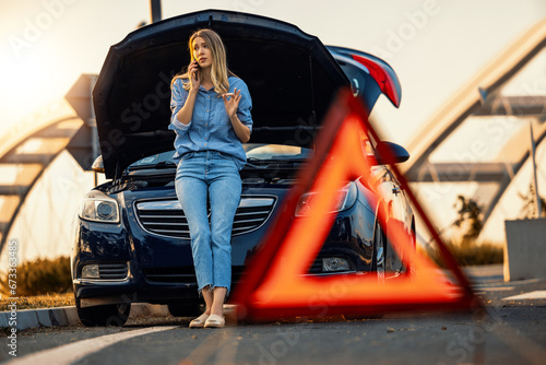Konstfotografi Woman driver using mobile phone during problem car