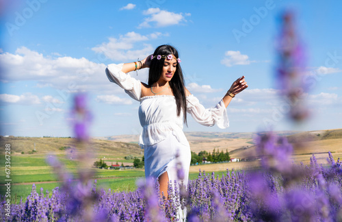 Fototapeta Naklejka Na Ścianę i Meble -  beautiful woman with through in lavender flowers field