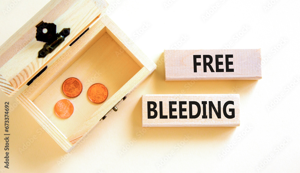 Free bleeding symbol. Concept words Free bleeding on beautiful wooden block. Beautiful white table background. Wooden chest with coins. Gen Z, motivational freedom free bleeding concept. Copy space. Free bleeding symbol. Concept words Free bleeding on beautiful wooden block. Beautiful white table background. Wooden chest with coins. Gen Z, motivational freedom free bleeding concept. Copy space.