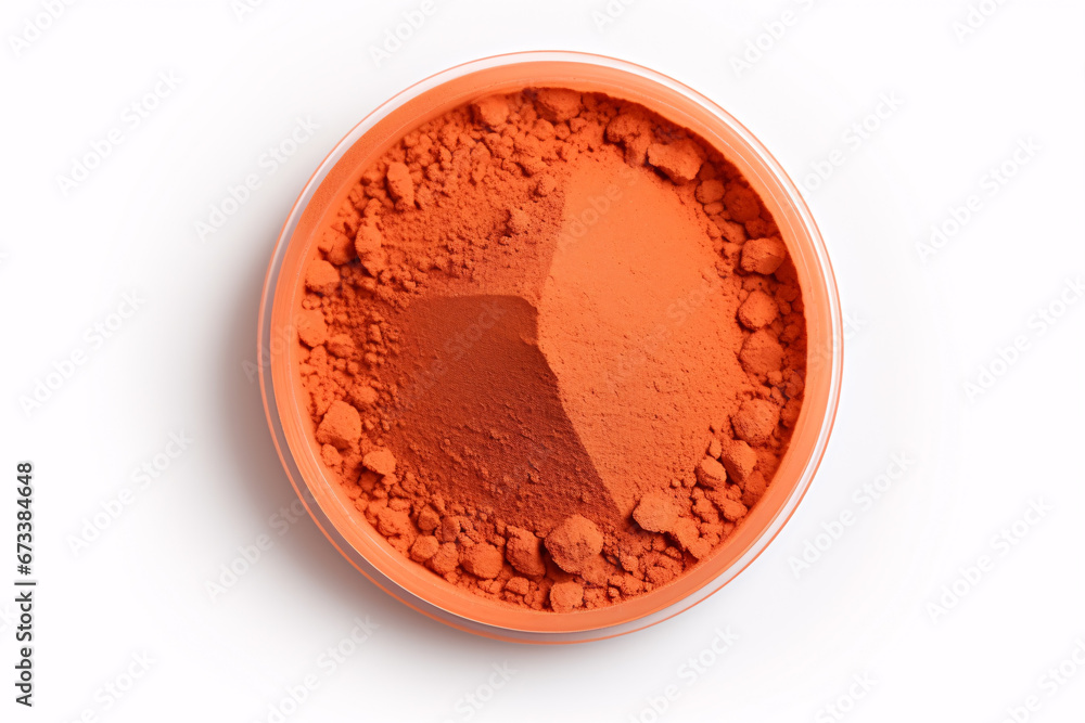 Vibrant-tangerine hue eyeshadow pigments in a powdered state are pictured alone on a snowy background. Vibrant-tangerine hue eyeshadow pigments in a powdered state are pictured alone on a snowy background.