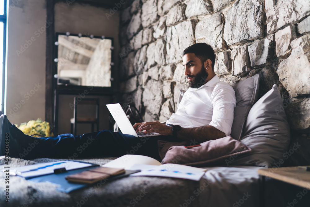 Ethnic businessman working remotely on computer Ethnic businessman working remotely on computer