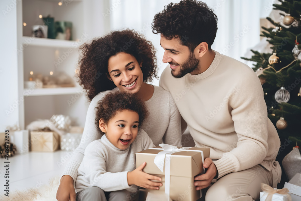 Mixed race family mother, father and child unpacking Christmas gift box together
