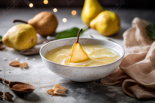 Bowl of Creamy Pear Soup topped with pear slice and swirls of cream. Horizontal, side view. © Iryna