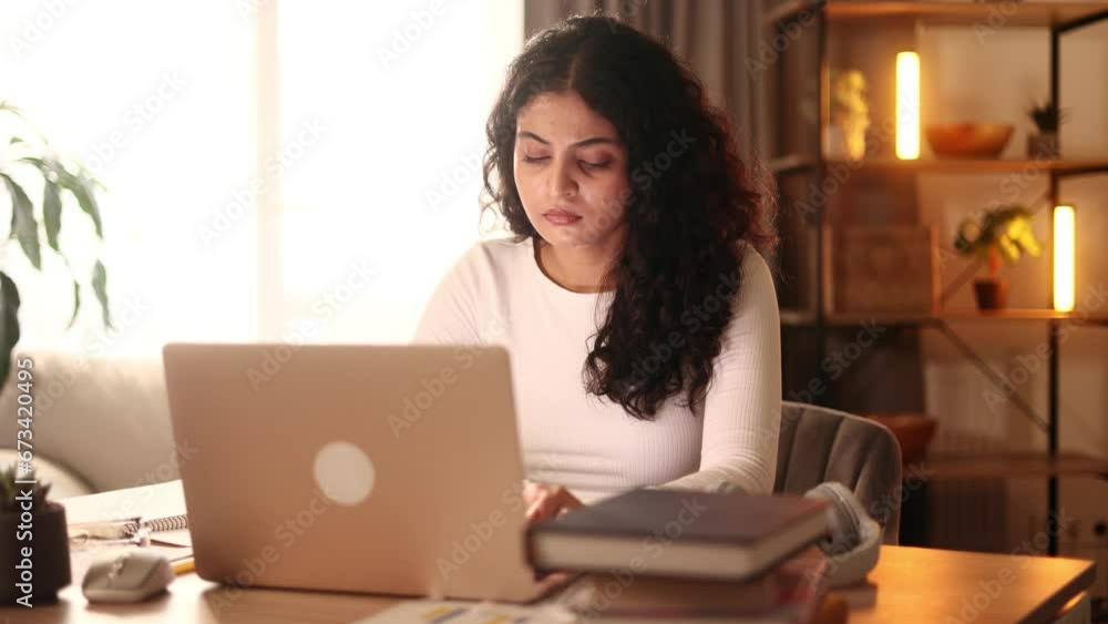 Confident freelancer having distance remote work typing browsing scrolling products in internet online store on laptop computer while sitting at desk workplace at home Confident freelancer having distance remote work typing browsing scrolling products in internet online store on laptop computer while sitting at desk workplace at home