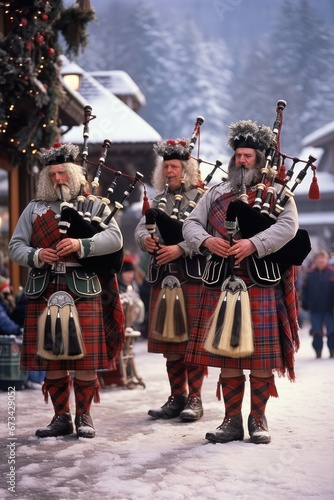 musicians in Scottish clothing perform Christmas carols on bagpipes in the square © DyrElena