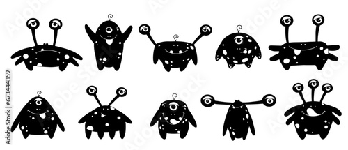 Set of silhouettes of small funny monsters.Vector graphics.