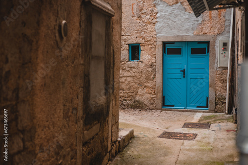 Beautiful blue wooden door in the picturesque city of Cres, Croatia. Beautiful narrow streets in the coastal city, corner and enchanting doors.