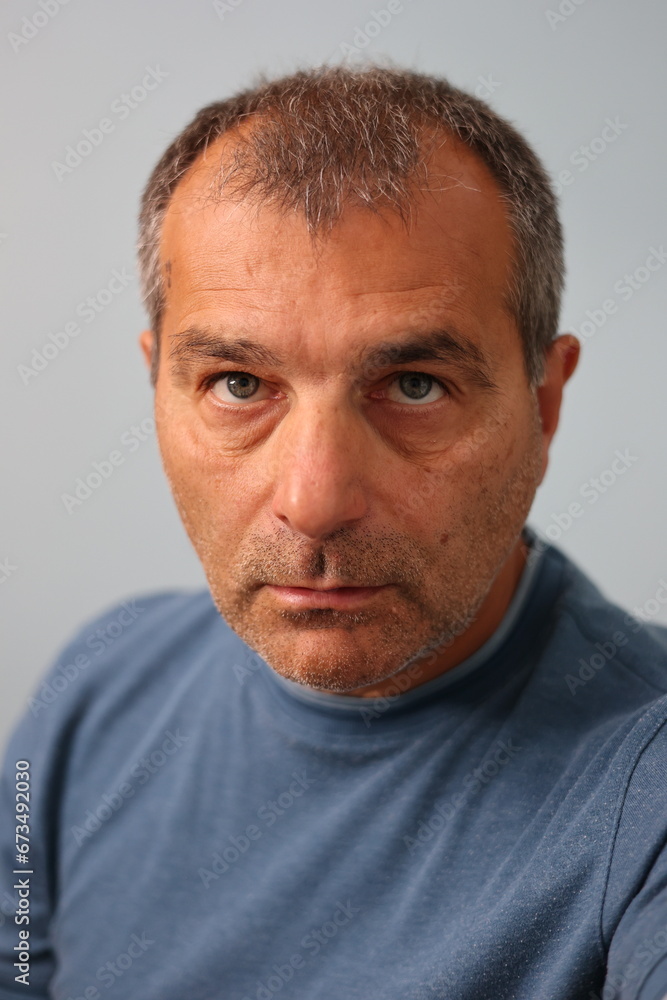 Fototapeta premium Close up portrait of serious mature male staring at the camera