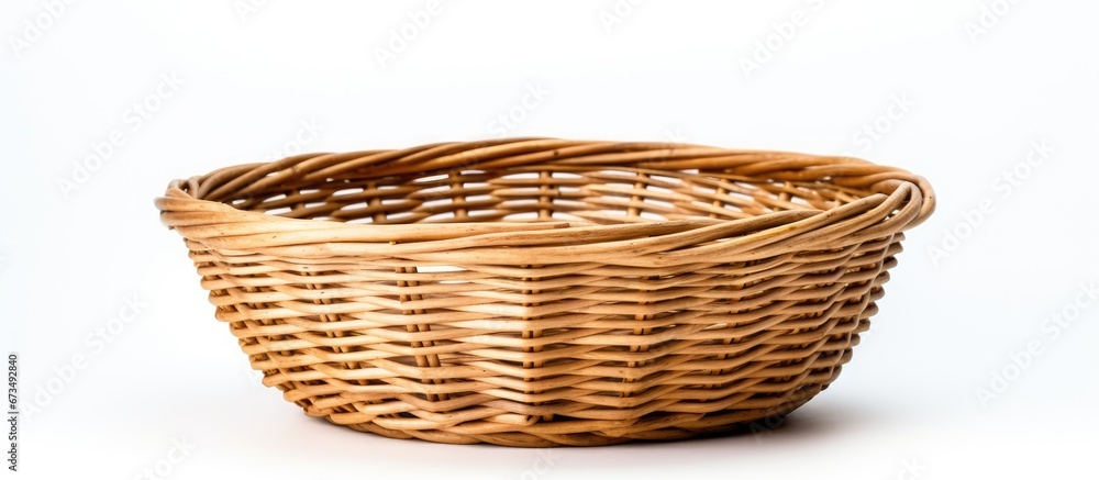 Obraz premium A basket made of rattan set apart against a white backdrop