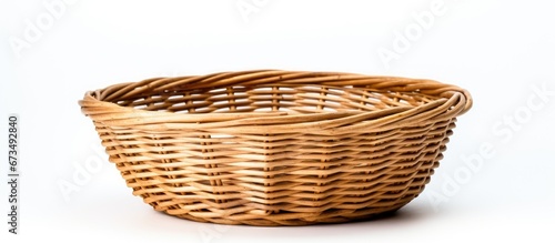 A basket made of rattan set apart against a white backdrop
