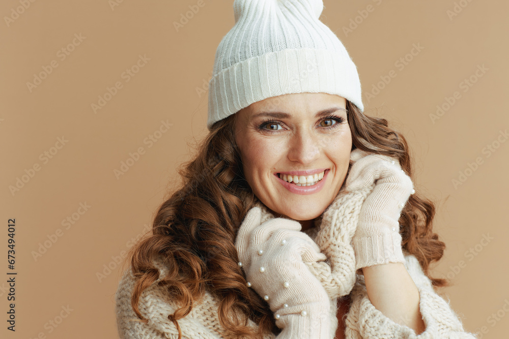 happy stylish woman against beige wrapped in collar
