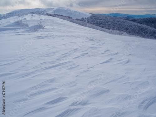 Winter mountain landscape. Mountain peaks covered with snow. View from Mala Rawka to Wielka Rawka. Bieszczady Mountains. Poland