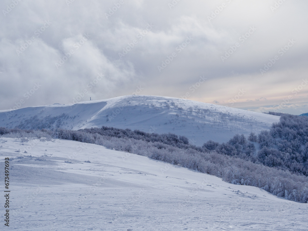 Winter mountain landscape. Snow-covered trees on mountain slopes. View from Mala Rawka to Beskid Monutain Range.  Bieszczady Mountains. Poland.